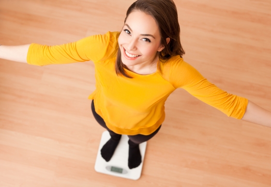 Woman standing on weighing scale